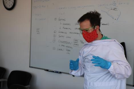 Medical resident shows how to don PPE