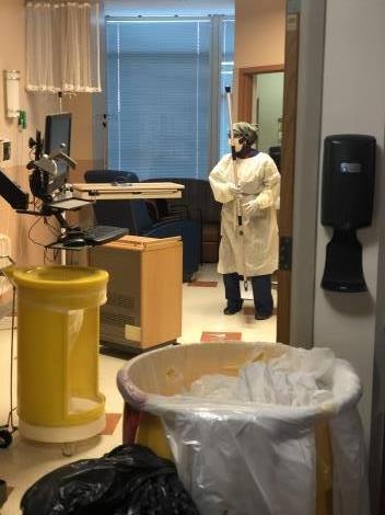 Denver Health staff member Andra Olsen cleaning