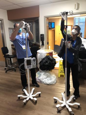 Denver Health staff disinfect IV poles