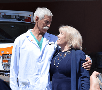 Ima Holcomb and Dr. Ernest Gene Moore at renaming of Denver Health level 1 trauma center and patient story