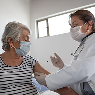 Hispanic/Latino woman getting vaccinated COVID-19 Denver Health