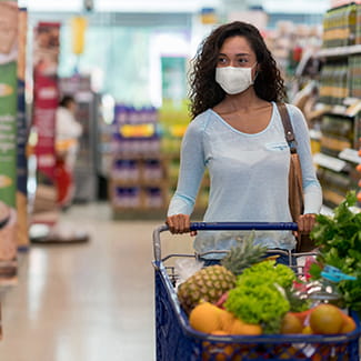 Woman shopping at the grocery store with mask on Denver Health