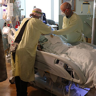 Taylor Nix and Christopher Whelchel with COVID patient Denver Health