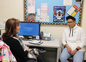 Kathy Sproule with student at North High School SBHC