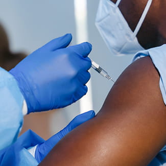 man getting coronavirus vaccine Denver Health
