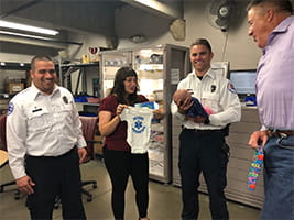 Denver Health paramedics present gifts to new mother