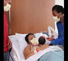 mom giving birth with nurse help at Denver Health