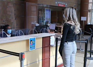 woman checking in for Denver Health clinic appointment during COVID-19