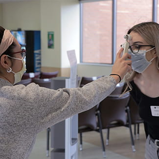 Woman getting her temperature checked during COVID-19 at Denver Health