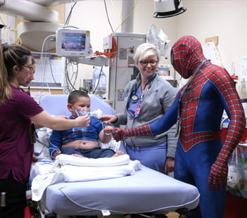 Superhero Spiderman meets with child patient