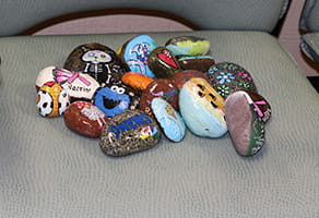 Margie Garcia paints rocks and leaves them at Denver Health