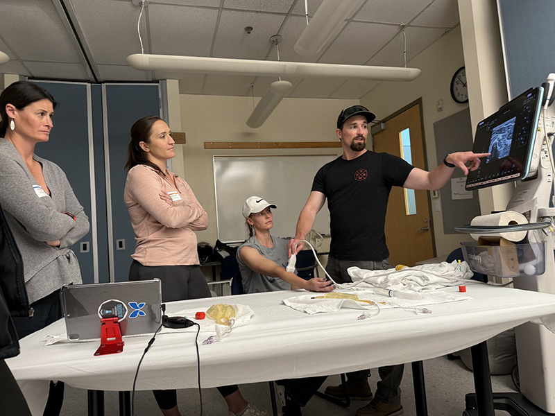 a man demonstrates an ultrasound machine