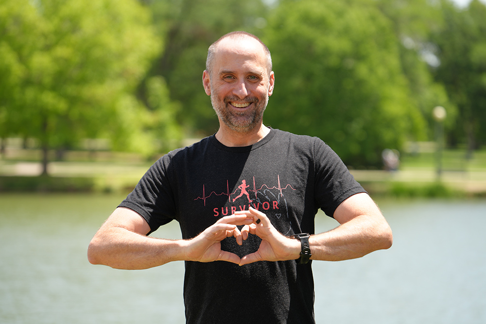Jon Froelich creates a heart shape with his hands.