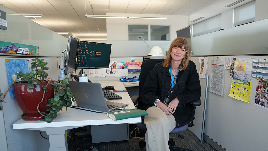 Charlotte Olsen sits at her desk