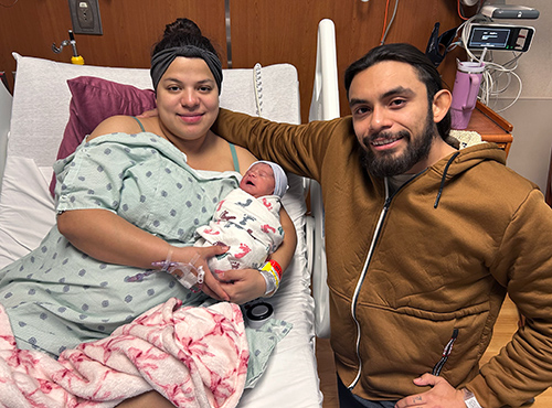 Parents Claudia Flores-Rios and Erik Flores hold their new baby girl, Oulahni.