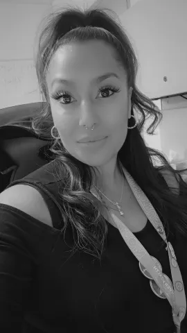 A black and white portrait of Krystin