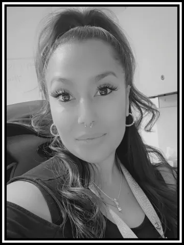 A black and white portrait of Krystin