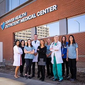 Denver Health's Bariatric Surgery Team stands in front of the Outpatient Medical Center on Denver Health's main campus.