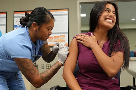 A woman receives a flu shot