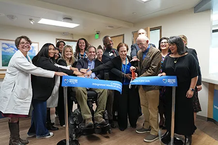 a group participates in a ceremonial ribbon cutting