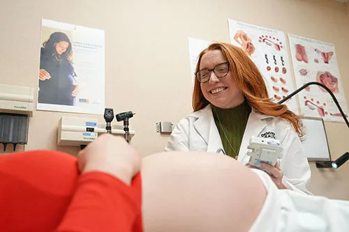 Kylie Culp, MD, an OB/GYN generalist and medical director of OB PEAR, examines a pregnant patient.